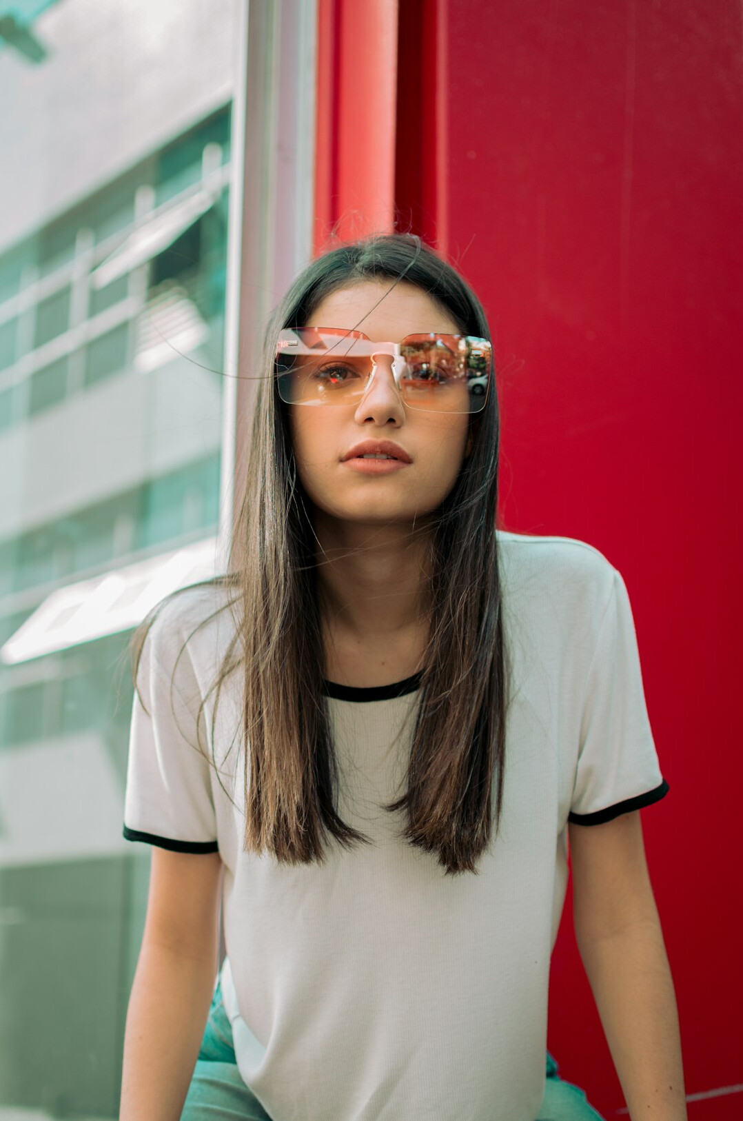 Studio portrait of a young Brazilian woman with straight hair and glasses